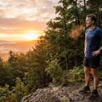 Man running in the forest sunrise